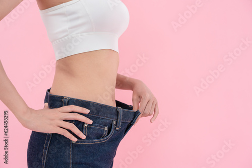 Women showing results of diet. Beautiful shape. female have a reduced waist size after under going a weight loss corse. can not wear jeans due to weight loss. balance, control, routines, exercise..
