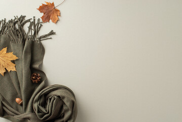 Elevate your fall fashion with chic and warm essentials: a fashionable soft cashmere scarf with maple leaves on top view image on a grey isolated background, leaving space for text or advertising
