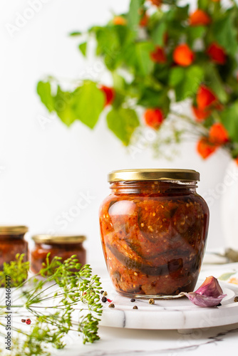 Preserving vegetables for the winter, canned chopped eggplant with carrots and tomatoes, copy space