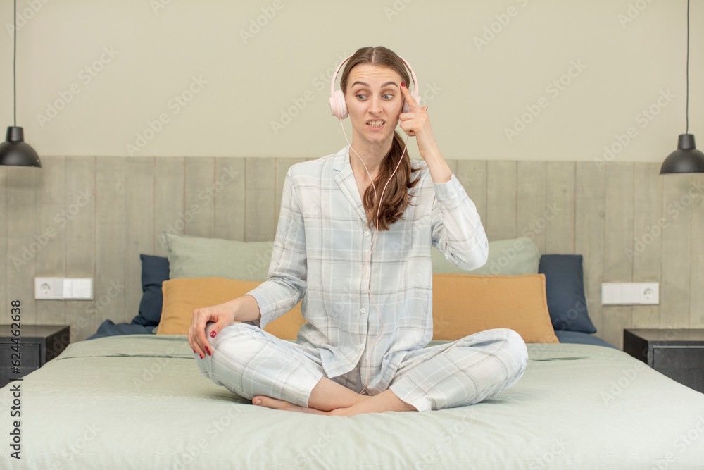 looking surprised, realizing a new thought, idea or concept. bed time concept looking surprised, realizing a new thought, idea or concept. bed time concept