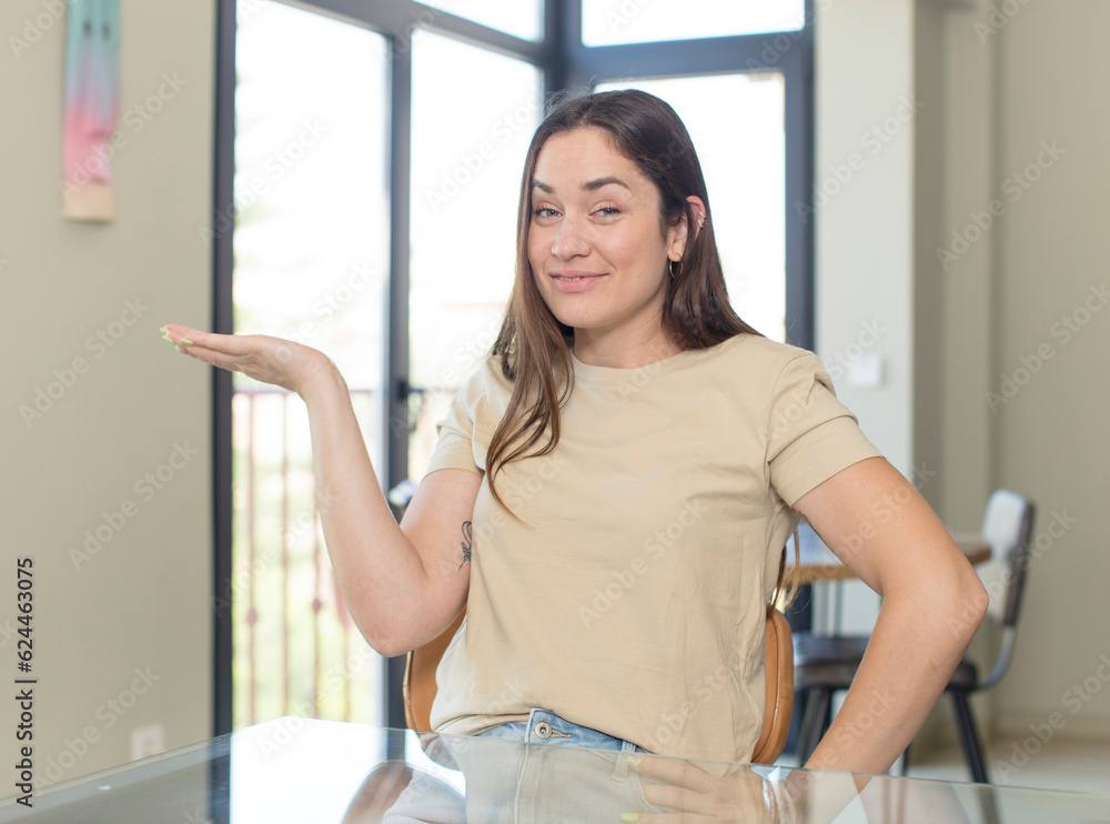young pretty woman smiling, feeling happy, carefree and satisfied, pointing to concept or idea on copy space on the side young pretty woman smiling, feeling happy, carefree and satisfied, pointing to concept or idea on copy space on the side