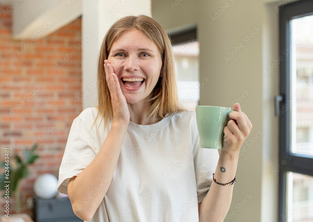 young pretty woman feeling happy and astonished at something unbelievable. coffee cup concept young pretty woman feeling happy and astonished at something unbelievable. coffee cup concept