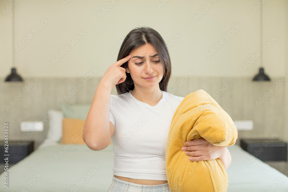 young woman looking surprised, realizing a new thought, idea or concept. nightwear concept young woman looking surprised, realizing a new thought, idea or concept. nightwear concept
