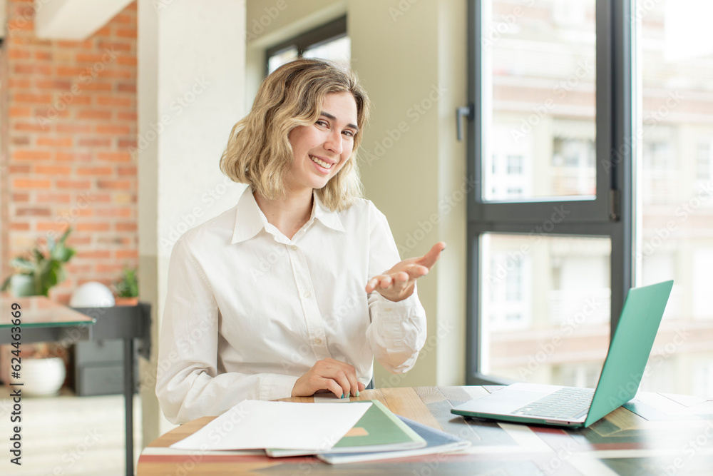 pretty woman smiling happily and offering or showing a concept. home work telecommuting concept pretty woman smiling happily and offering or showing a concept. home work telecommuting concept