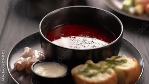Put sour cream in borscht beetroot soup, the first hot dish with pampushka with garlic photo