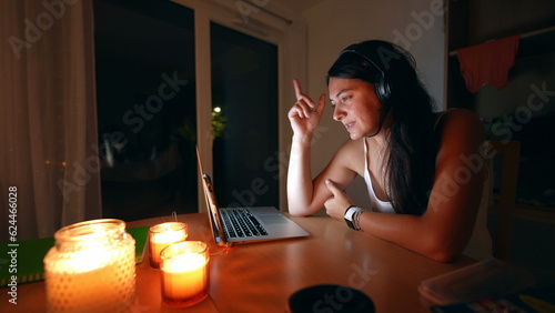 Woman speaking with family member with technology communication at night