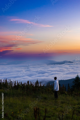 landscape in the mountains, sunset, sunrise, a man looks at the horizon, conquering the peaks, tourist, hiking, silhouettes of peaks, Montenegrin mountain range, Carpathians, travel, screensaver