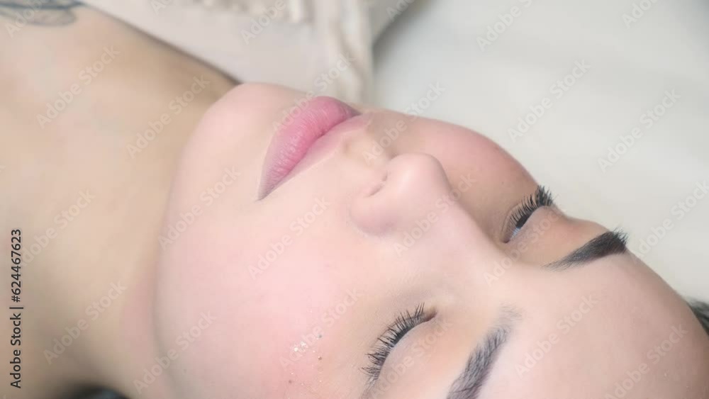 Permanent makeup procedure applying rose red pigment using tattoo machine in beautician salon. Microblading tattoo lips. Permanent makeup procedure applying rose red pigment using tattoo machine in beautician salon. Microblading tattoo lips.