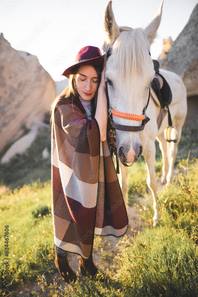 beautiful girl outdoors in the mountains with her faithful horse