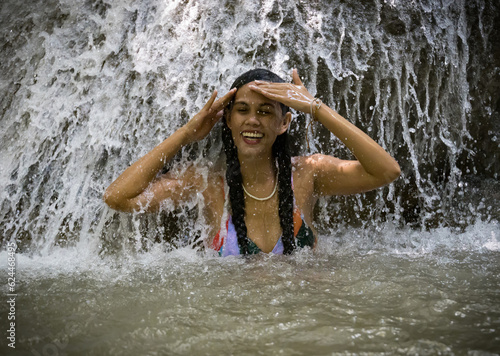 smiling girl in a waterfall