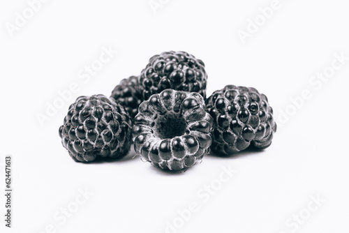 Macro shoot of sweet black raspberries on white background.