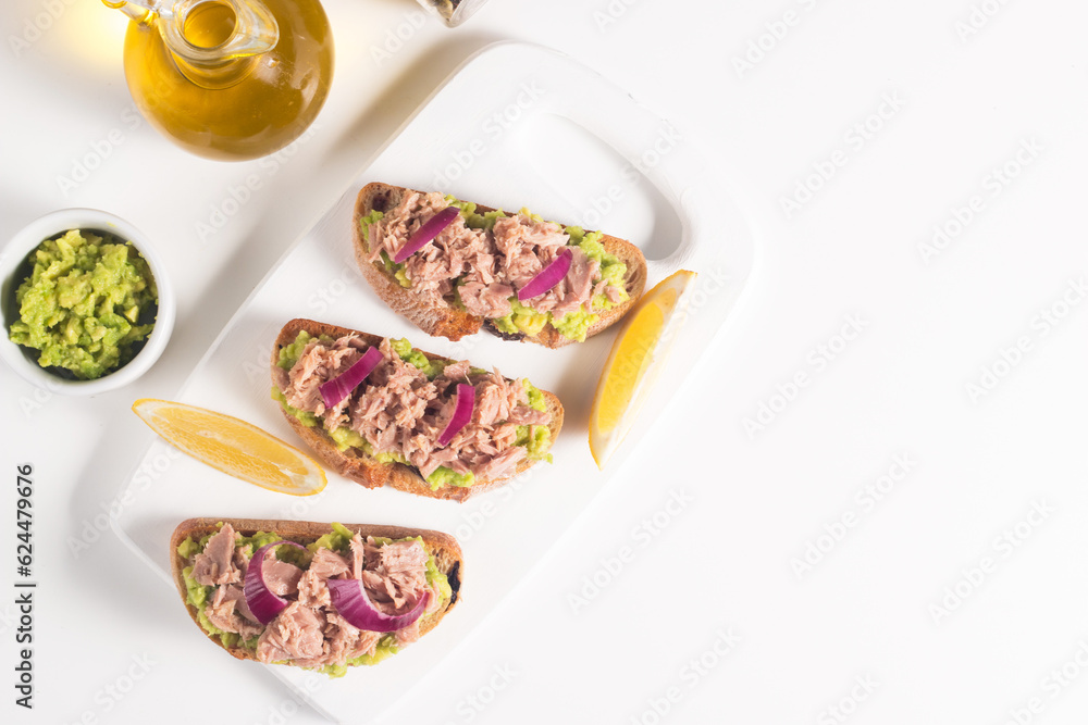 Toast with Canned Tuna. Fish open sandwich with red onion and lemon. Toast with Canned Tuna. Fish open sandwich with red onion and lemon.