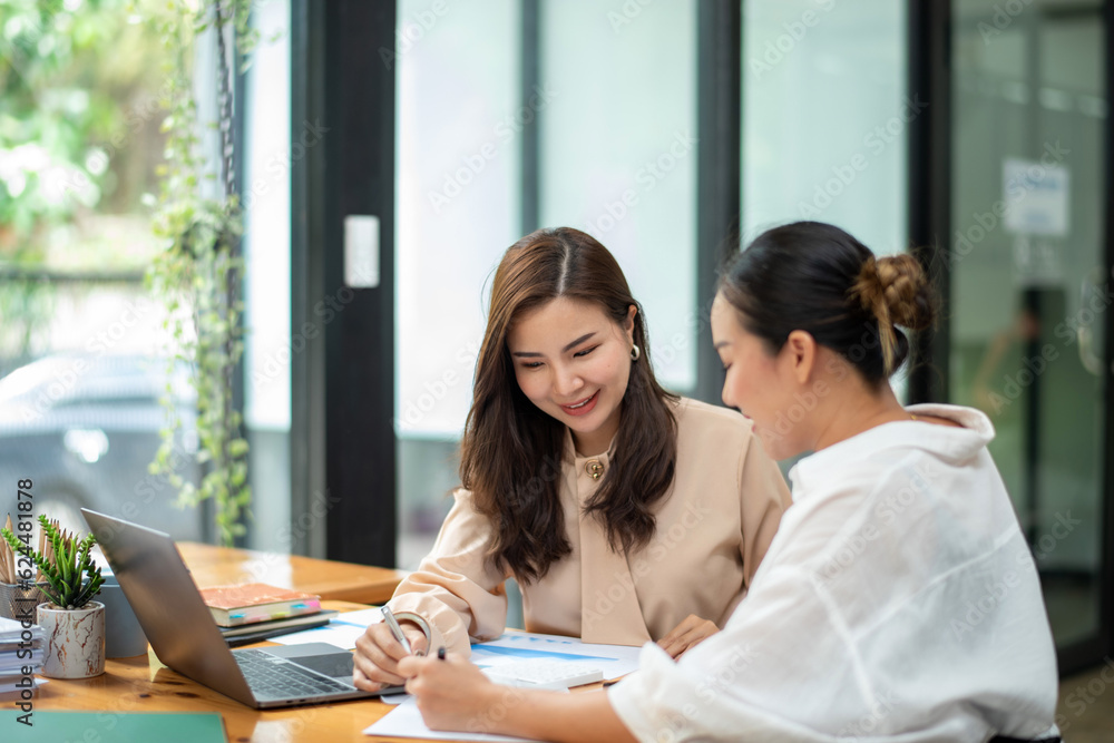 Two colleague businesswoman discussion and brainstorming business ideas. Consulting and marketing planning Two colleague businesswoman discussion and brainstorming business ideas. Consulting and marketing planning