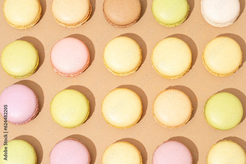 Fototapeta premium An assortment of macarons are neatly arranged in rows on a flat surface