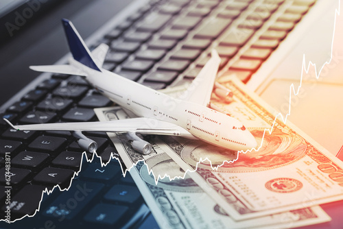 Toy aircraft, dollar bills and rising chart representing airfare rise