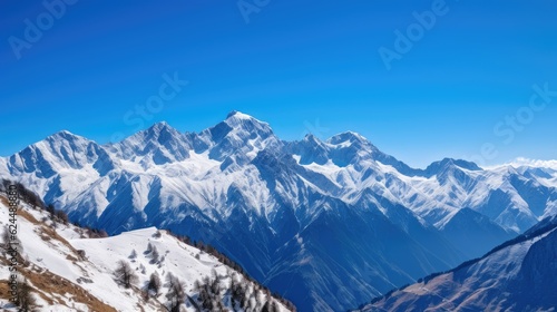 Snow-capped mountains against a clear sky © Neo