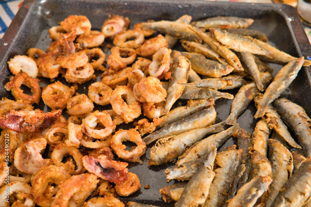 fried calamari and anchovies on a tray