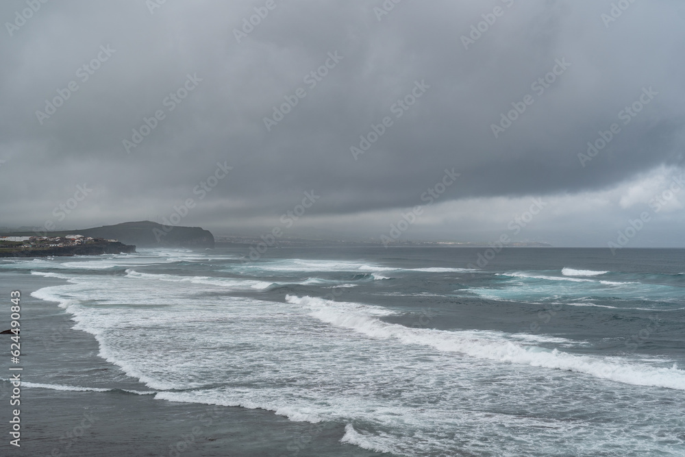 Sea coming in waves on the shore in the Azores of Portugal. Sea coming in waves on the shore in the Azores of Portugal.