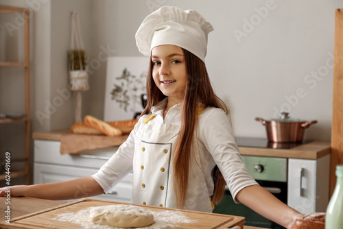 Smiling young girl chef in ...