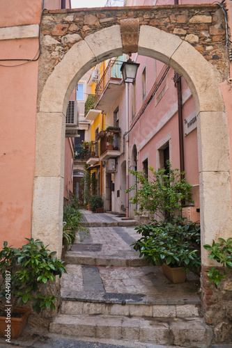 Fototapeta Naklejka Na Ścianę i Meble -  Taormina, Italy, Sicily, old town, bars, alleys, old facades, stairs with a Mediterranean flair