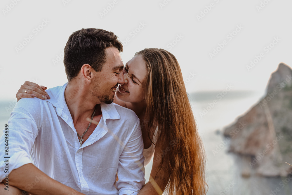 Beautiful young loving couple man of Middle Eastern appearance and a Caucasian woman hug, kiss at sunrise. Beautiful young loving couple man of Middle Eastern appearance and a Caucasian woman hug, kiss at sunrise.