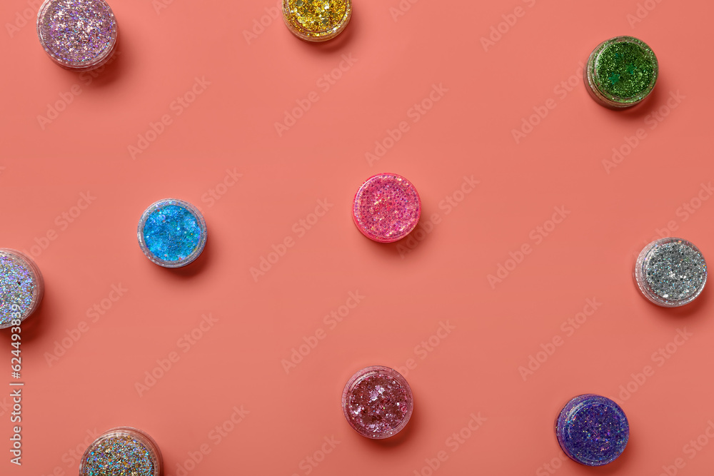 Jars of glitter on pink background Jars of glitter on pink background