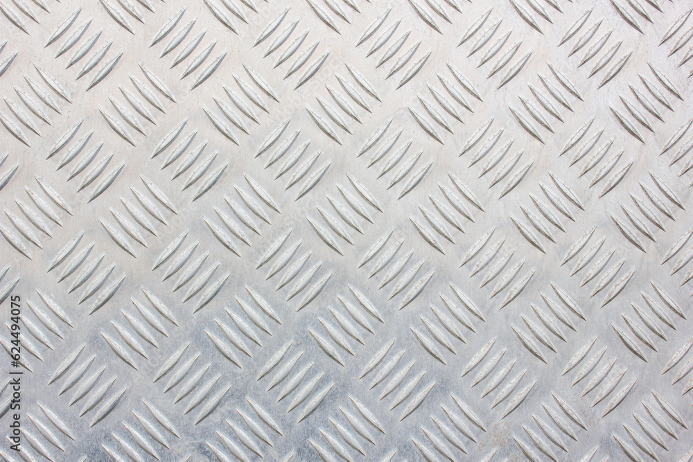 Metal ribbed surface.Metal plate with diamond pattern.Metal with diagonal lines. Steel floor to prevent slipping. Metal ribbed surface.Metal plate with diamond pattern.Metal with diagonal lines. Steel floor to prevent slipping.