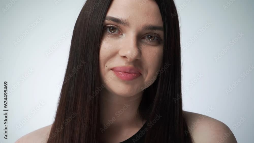 Young woman open eyes on white background. Close up of smiling girl looking at camera in studio. Strait hair fashion model face smiling. Young woman open eyes on white background. Close up of smiling girl looking at camera in studio. Strait hair fashion model face smiling.