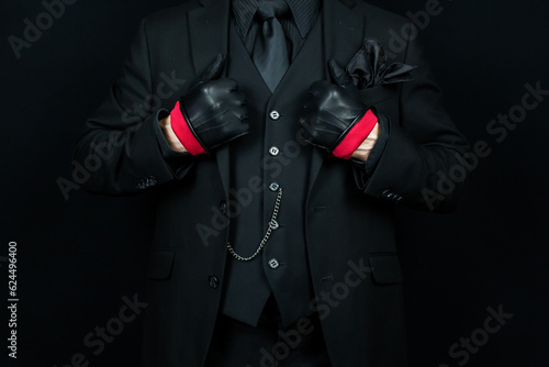 Portrait of Stylish Man in Dark Suit and Leather Gloves. Mafia Hit Man or Gentleman Gangster.