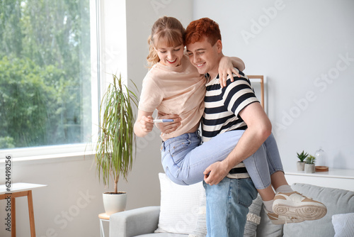 Excited young couple celebr...