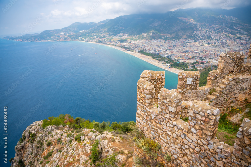 Aerial view of Cleopatra Beach from Alanya Castle with ruin of medieval wall on foreground, Turkey