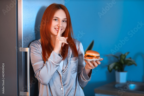 Young woman with tasty burg...