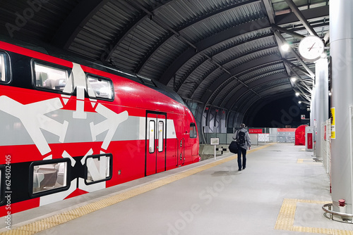 In Moscow city Russia a traveler with a backpack and luggage leave Aeroexpress train at the urban railway station to make their travel journey