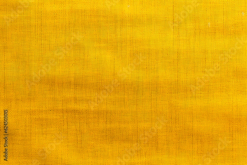 yellow fabric texture with subtle horizontal lines and variations close up photo