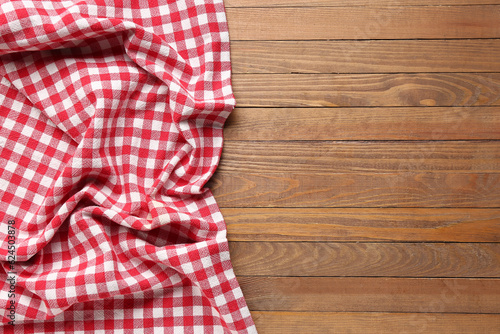 Crumpled red napkin on wooden background
