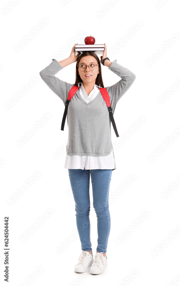 Female student with apple and books on white background