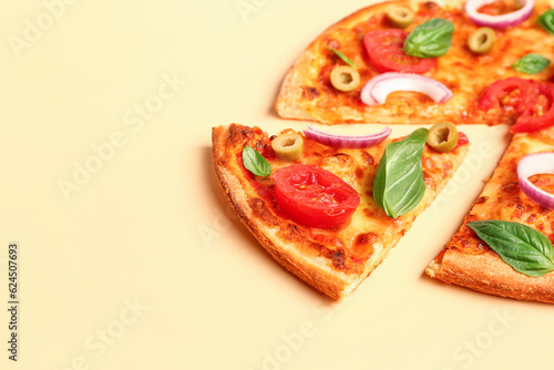 Tasty pizza with olives, tomatoes and basil on yellow background