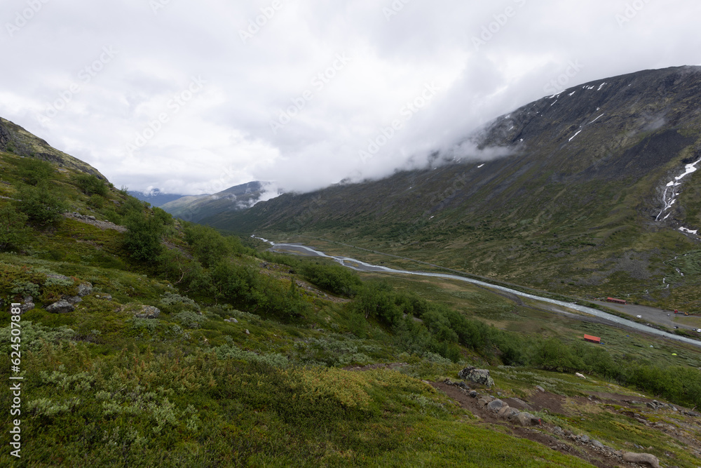 Fototapeta premium Galdhopiggen, Norway - July 3rd, 2023: The mountain landscape on the hike to the peak of Galdhopiggen In Jotunheimen National Park, Norway