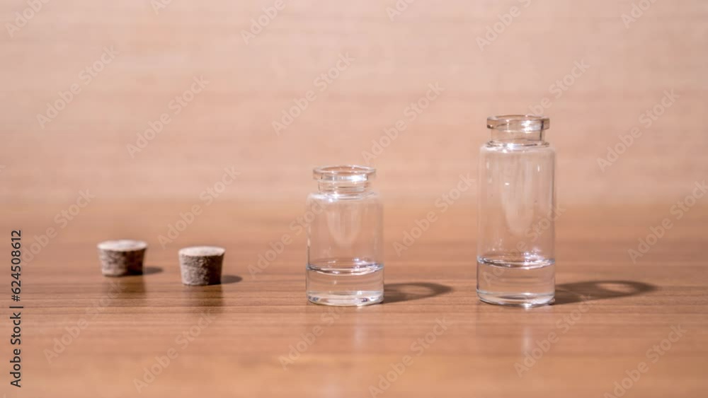 Glass flacons are filled with transparent liquid Glass flacons are filled with transparent liquid