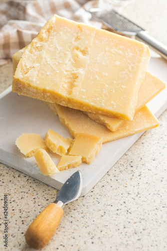 Tasty parmesan cheese on kitchen table.