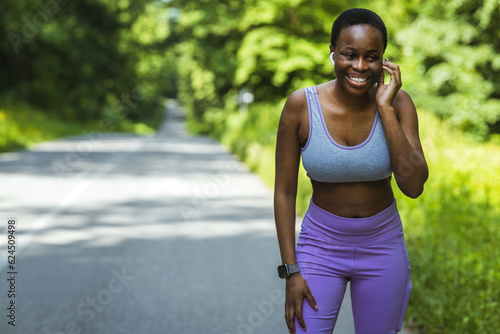 Shot of a young woman listening to music while on a run. Portrait of a sporty young woman running outdoors.