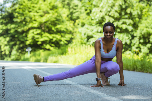 Full length shot of an attractive young sportswoman warming up for a workout outdoors.