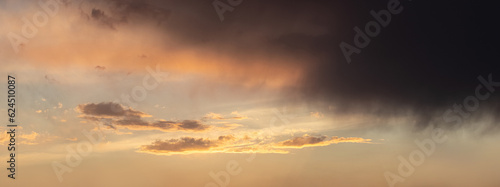 Fototapeta Naklejka Na Ścianę i Meble -  Dark storm cloud in a dramatic sky during sunset