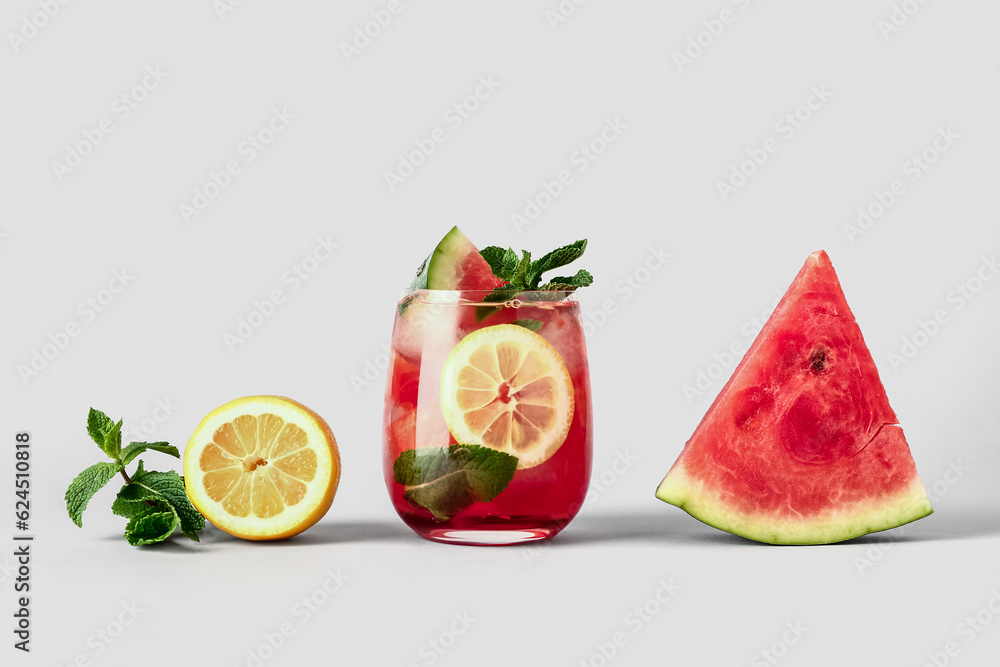 Glass of fresh watermelon lemonade with mint on white background Glass of fresh watermelon lemonade with mint on white background