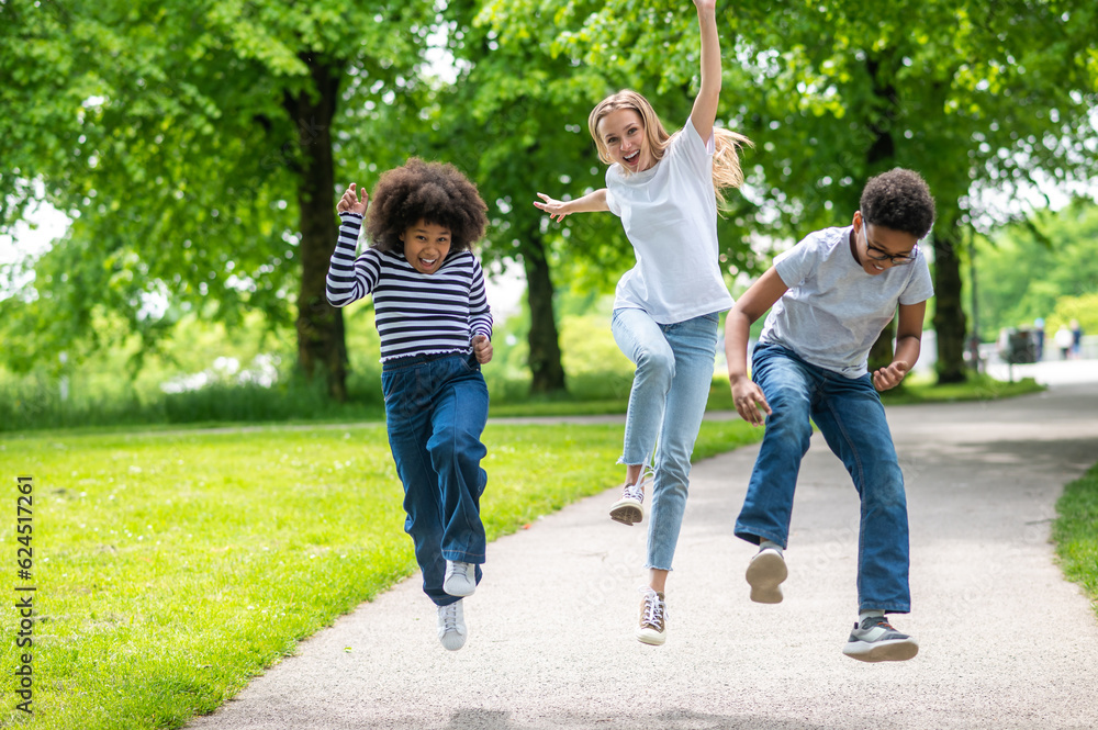 Fototapeta premium Friends having fun in the park and feeling good together