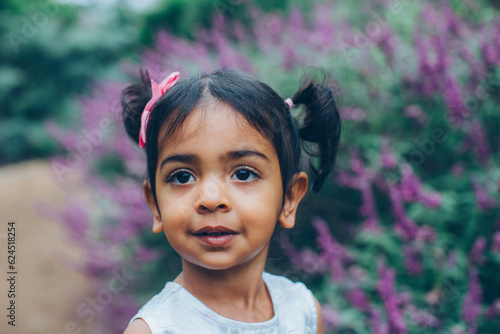 Photography close up beautiful indian little girl in the park with trees and greenery