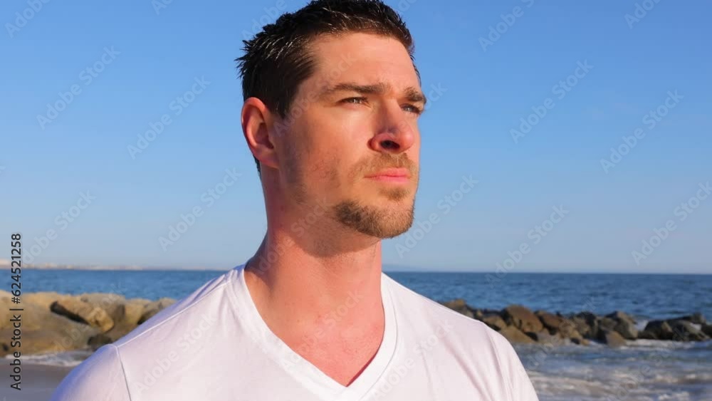 Close-up of an athletic man walking at the beach in Southern California. Slow Motion. Close-up of an athletic man walking at the beach in Southern California. Slow Motion.