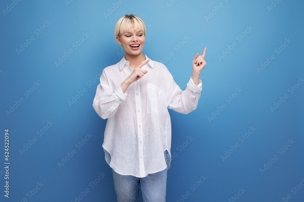 well-groomed cute blond fashionable woman with a short haircut is dressed in a white shirt holding a smartphone and is upset well-groomed cute blond fashionable woman with a short haircut is dressed in a white shirt holding a smartphone and is upset