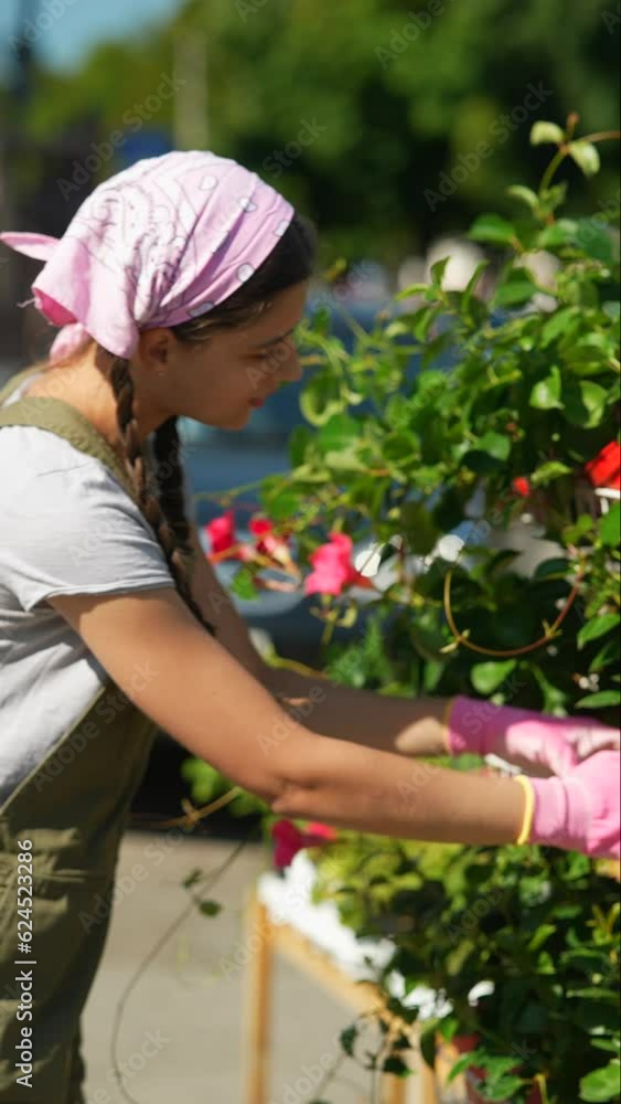 Young woman farmer at the farmers plants market, preparing to sell the product Young woman farmer at the farmers plants market, preparing to sell the product