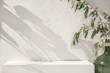 White empty concrete textured wall and podium stage background, green glass vase with plants, neutral sustainable natural brand product showcase template, mock up with copy space
